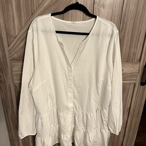 New without tags white tunic with ruffles around bottom hem.